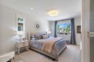 Bedroom featuring light carpet and recessed lighting
