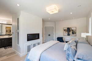 Bedroom with recessed lighting and connected bathroom
