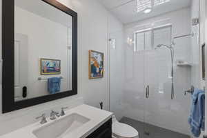 Full bath with vanity and a shower stall