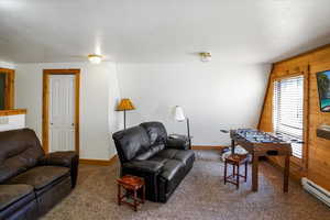 Living area featuring carpet flooring and a baseboard radiator