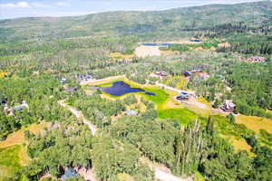 Aerial view of property and surrounding area featuring a water and mountain view