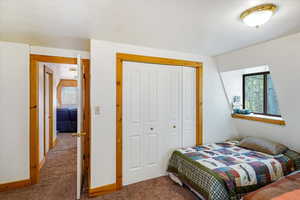 Bedroom with carpet and a closet
