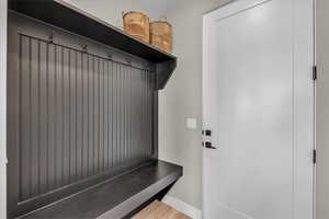 Mudroom with baseboards and wood finished floors