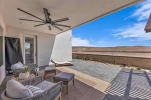 Fenced backyard featuring ceiling fan, a patio, and outdoor lounge area