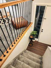 Stairs featuring wood finished floors and baseboards