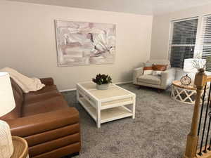 Carpeted living room with baseboards
