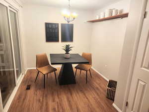 Dining room featuring wood finished floors and a chandelier