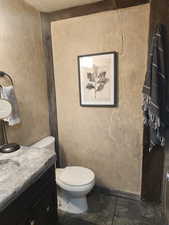 Bathroom featuring vanity and stone tile floors