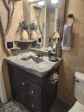 Bathroom with vanity and a textured wall