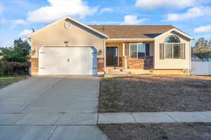 Ranch-style home with an attached garage, brick siding, concrete driveway, and roof with shingles