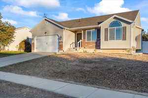 Ranch-style house featuring driveway, a garage, and brick siding