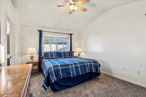 Bedroom with carpet, lofted ceiling, and a ceiling fan