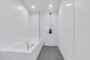Full bath featuring a bath, a tile shower, and recessed lighting