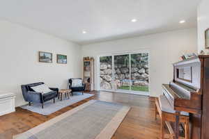 Living area featuring wood-type flooring and recessed lighting