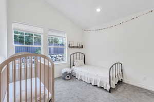 Bedroom featuring vaulted ceiling, carpet floors, and recessed lighting
