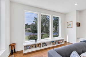 Sitting room with wood finished floors and recessed lighting