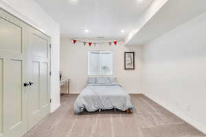 Carpeted bedroom with baseboards and recessed lighting
