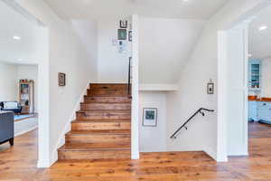 Staircase featuring recessed lighting and wood finished floors