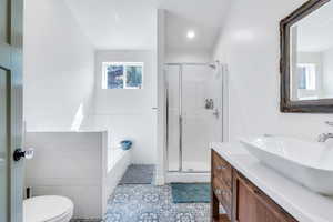 Full bathroom with a stall shower, vanity, a bath, tile patterned flooring, and recessed lighting