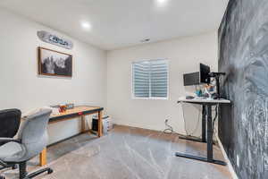 Home office with carpet and baseboards