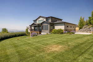 View of front of home with a front yard and stone siding