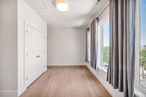 Empty room featuring light wood finished floors and baseboards
