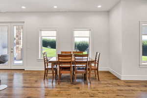 Dining space featuring healthy amount of natural light, wood finished floors, and recessed lighting