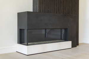 Detailed view of a fireplace and wood finished floors