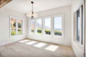 Unfurnished dining area featuring wood finished floors and a mountain view