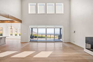 Unfurnished living room with light wood-style floors and a mountain view