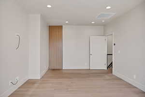 Empty room featuring recessed lighting and light wood-style flooring