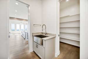 Bar featuring light wood-style floors and recessed lighting