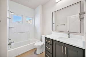 Bathroom featuring vanity and  shower combination