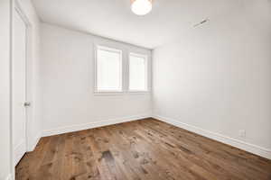 Empty room with wood finished floors and baseboards
