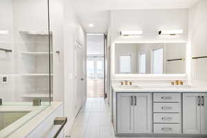 Bathroom featuring double vanity, tile patterned floors, and recessed lighting