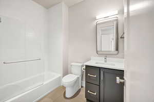 Bathroom featuring vanity, tile patterned flooring, and shower / bathtub combination