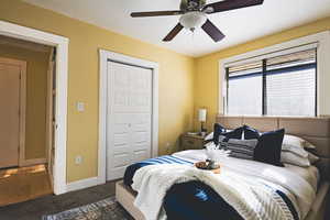 Bedroom featuring carpet flooring, a closet, and a ceiling fan