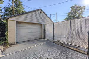 Detached garage featuring a gate