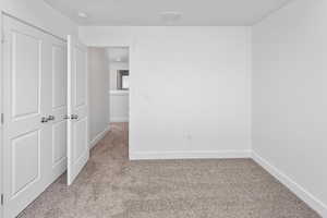 Unfurnished bedroom featuring carpet floors and a closet
