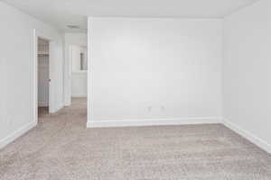 Carpeted empty room featuring baseboards