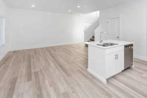 Bar featuring stairs, dishwasher, light wood-style floors, and recessed lighting