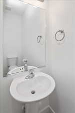 Half bath with a sink and toilet