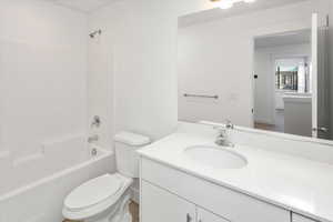 Full bath featuring vanity and bathing tub / shower combination