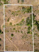 Aerial view of sparsely populated area featuring property parcel outlined