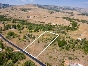 Overview of rural landscape featuring property parcel outlined and mountains
