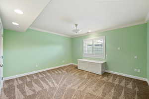 Carpeted empty room with crown molding and recessed lighting