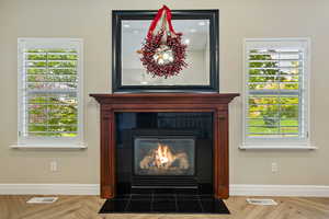 Detailed view of a fireplace with flush hearth and baseboards