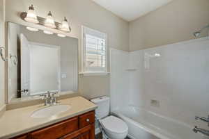 Full bath featuring vanity and shower / bath combination