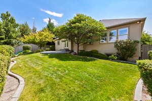 Rear view of property featuring stucco siding and roof with shingles