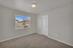 Unfurnished room with carpet floors and baseboards